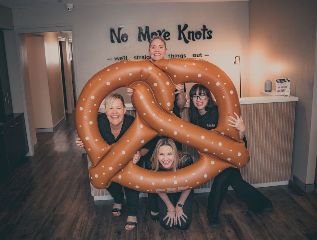 The No More Knots team with a giant pretzel